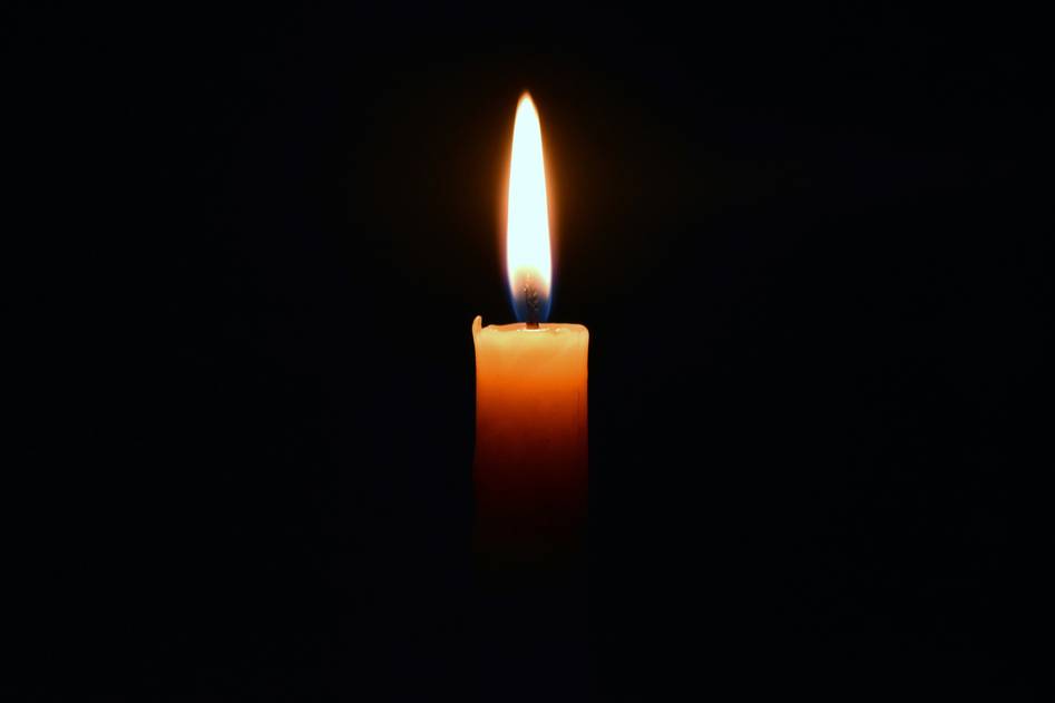 Handcrafted aromatherapy candle with dried lavender and soft linen backdrop